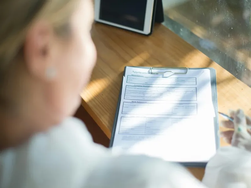 Nurse looking at immunization chart.