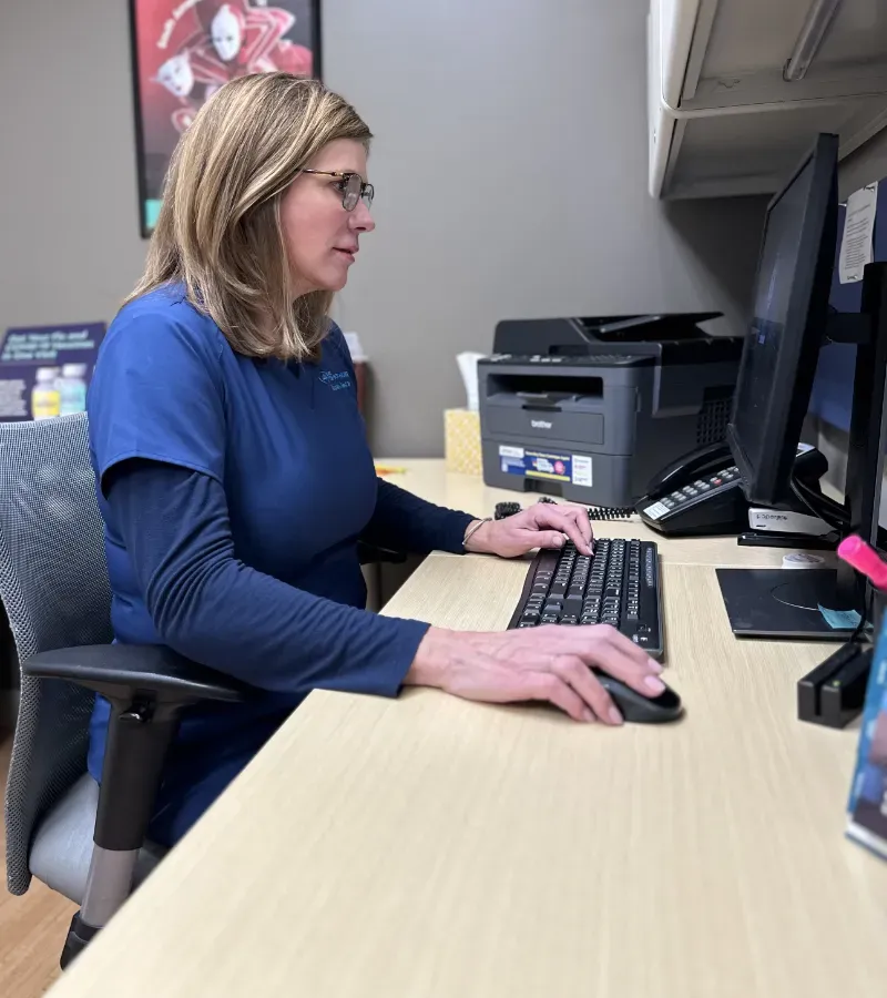 Office manager is preparing patient.