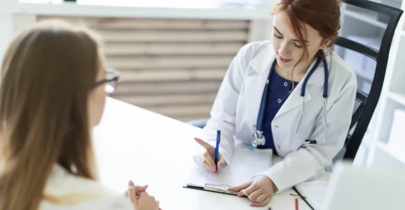 Two women discussing tetanus TDP vaccine at the clinic.