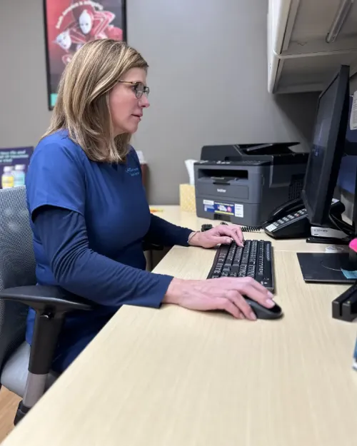 Office manager is preparing patient.