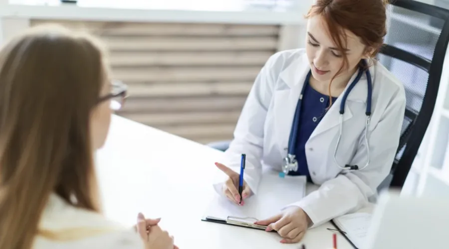 Two women discussing tetanus TDP vaccine at the clinic.