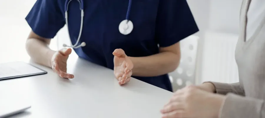 Nurse discussing college vaccination with patient.